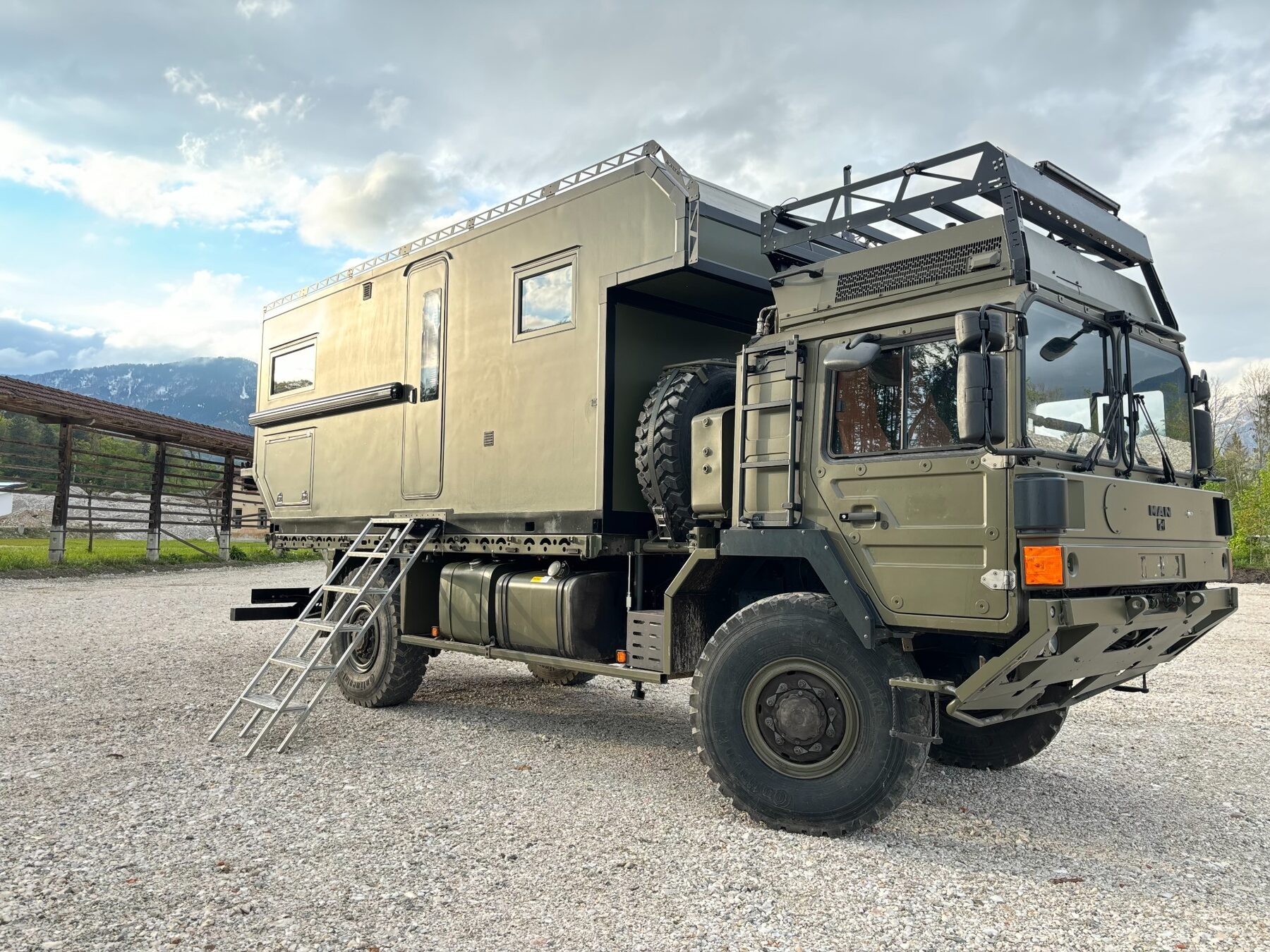 MAN 4x4 expedition truck with custom living box in the mountains